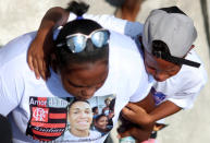 Relatives and friends of goalkeeper Christian Esmerio, 15, react during his burial after a deadly fire at Flamengo soccer club's training center, in Rio de Janeiro, Brazil February 10, 2019. REUTERS/Ricardo Moraes