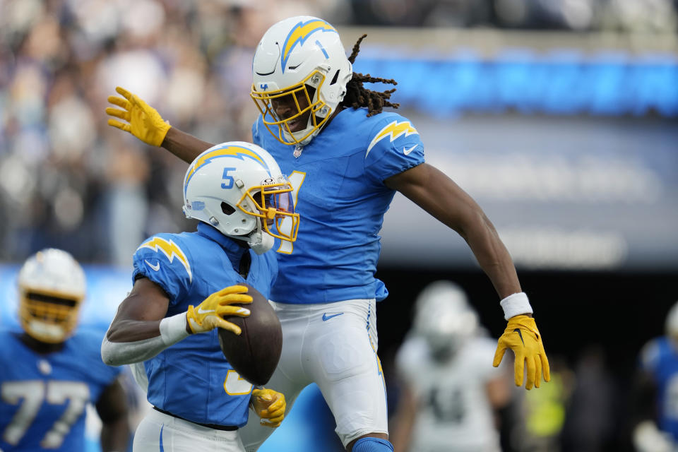 Los Angeles Chargers wide receiver Joshua Palmer (5) celebrates his catch with wide receiver Quentin Johnston (1) during the second half of an NFL football game against the Las Vegas Raiders Sunday, Oct. 1, 2023, in Inglewood, Calif. (AP Photo/Ashley Landis)