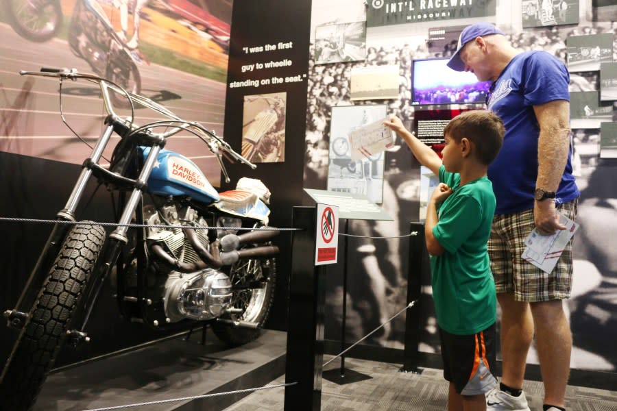 Bennett Noriega,age 5, and his grandfather, John Wegele, check out one of the many motorcycles on display at the Evel Knievel Museum in Topeka, Kansas on June 21, 2017. (Photo credit should read BETH LIPOFF/AFP via Getty Images)