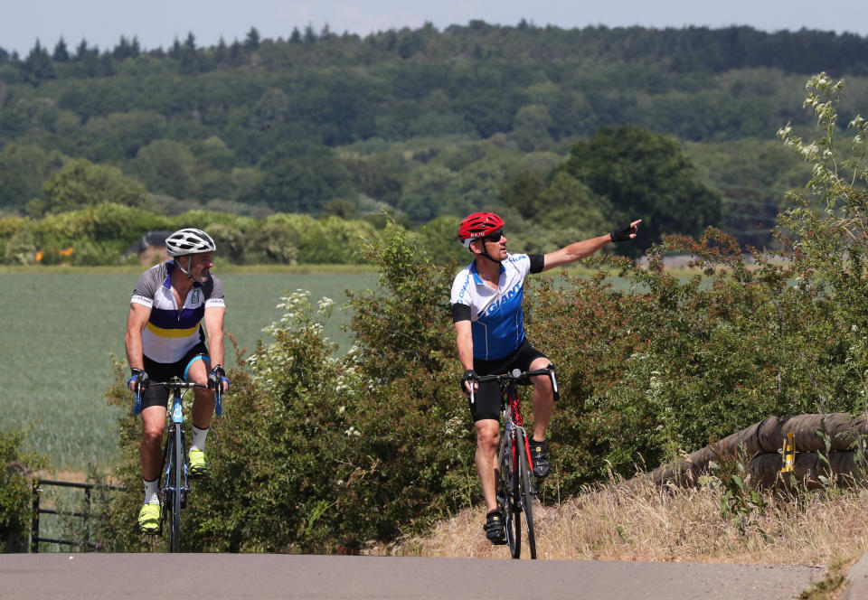 Cyclists cross the railway bridge in White Waltham, Berkshire, as coronavirus lockdown restrictions in England are eased.