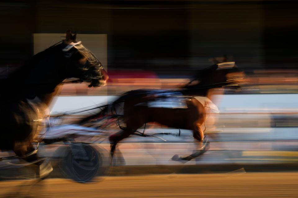 Sep 22, 2022; Delaware, Ohio, USA; Horses are seen being driven around the track during a warm-up lap in the 77th running of the Little Brown Jug harness race on Thursday at Delaware County Fairgrounds. Mandatory Credit: Joseph Scheller-The Columbus Dispatch