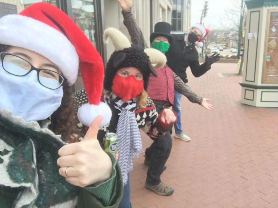 The Global Warblers pose while caroling in downtown Bloomington.