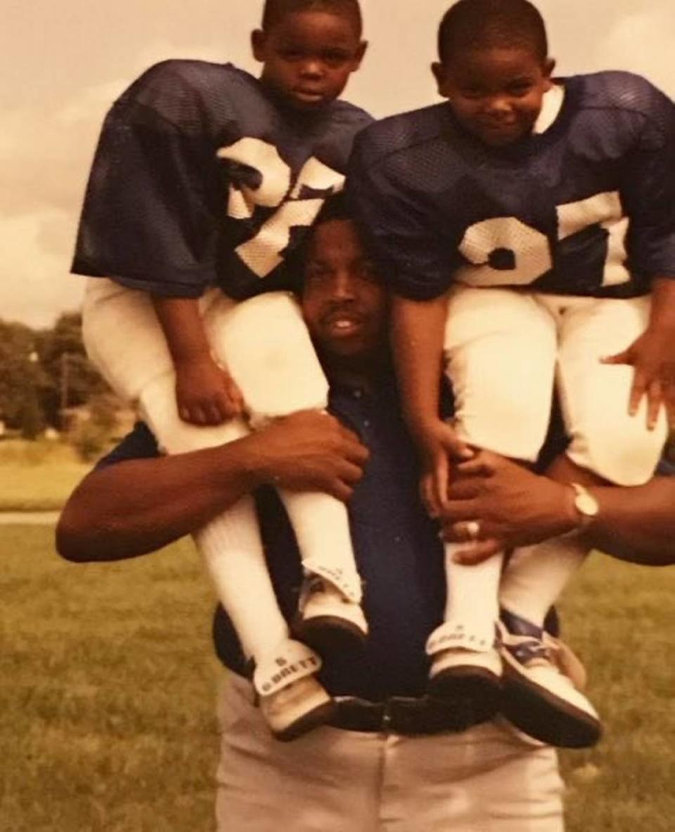 Former Harrodsburg High School football coach Alvis Johnson held his sons, Dennis, left, and Derrick upon his shoulders in this undated family photo. Both boys went onto standout careers for their father in high school and at the University of Kentucky.
