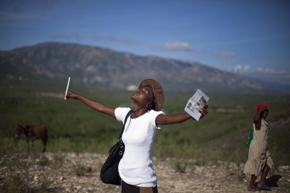A woman prays during a pilgrimage to Calvaire Miracle Mount, marking Good Friday in Ganthier, Haiti, Friday, April 18, 2014. Thousands of Haitians traveled to Ganthier, a small town east of Port-au-Prince where pilgrims hiked across the surrounding mountains. These were dotted with Stations of the Cross, depictions of the final hours in Jesus’ life. (AP Photo/Dieu Nalio Chery)