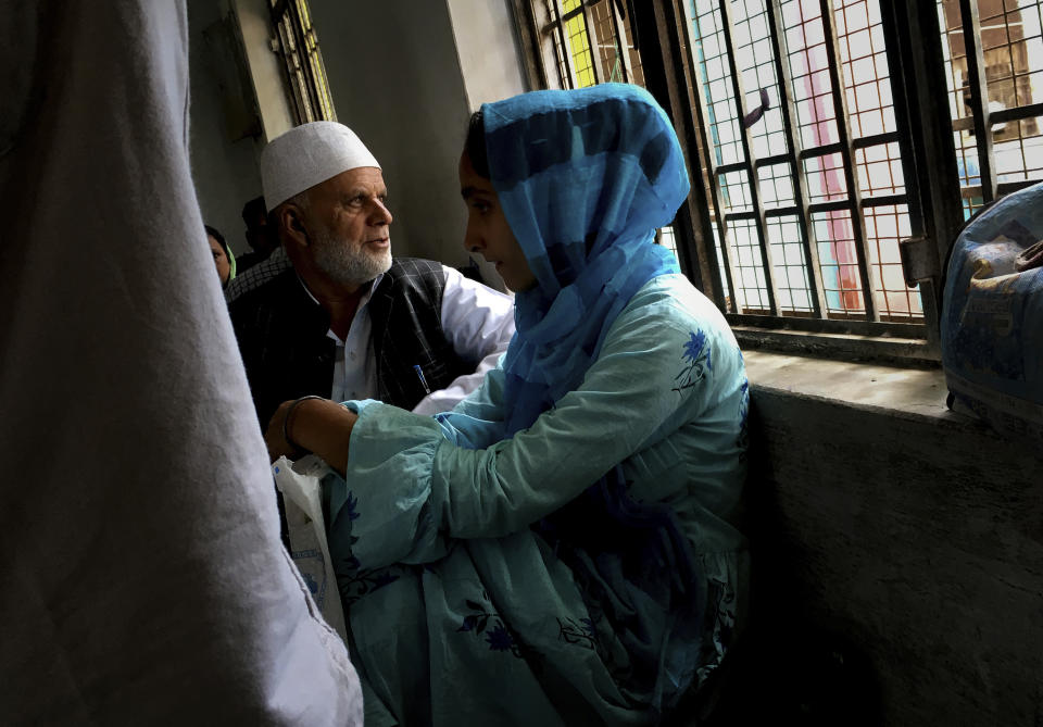 A Kashmiri family awaits their turn to meet a relative in Agra Central Jail in Agra, India, Friday, Sept. 20, 2019. Families from the Himalayan region of Kashmir have traveled nearly 1,000 kilometers (600 miles) in sweltering heat to meet relatives being held in an Indian jail in the city of Agra. At least 4,000 people, mostly young men, have been arrested in Indian-held Kashmir since the government of Prime Minister Narendra Modi imposed a security clampdown and scrapped the region’s semi-autonomy on Aug. 5, according to police officials and records reviewed by AP. (AP Photo/Altaf Qadri)