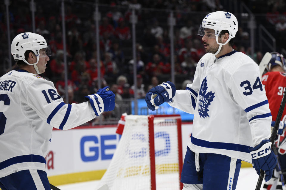 Toronto Maple Leafs center Auston Matthews (34) celebrates his goal against the Washington Capitals with right wing Mitchell Marner (16) during the second period of an NHL hockey game Tuesday, Oct. 24, 2023, in Washington. (AP Photo/Nick Wass)