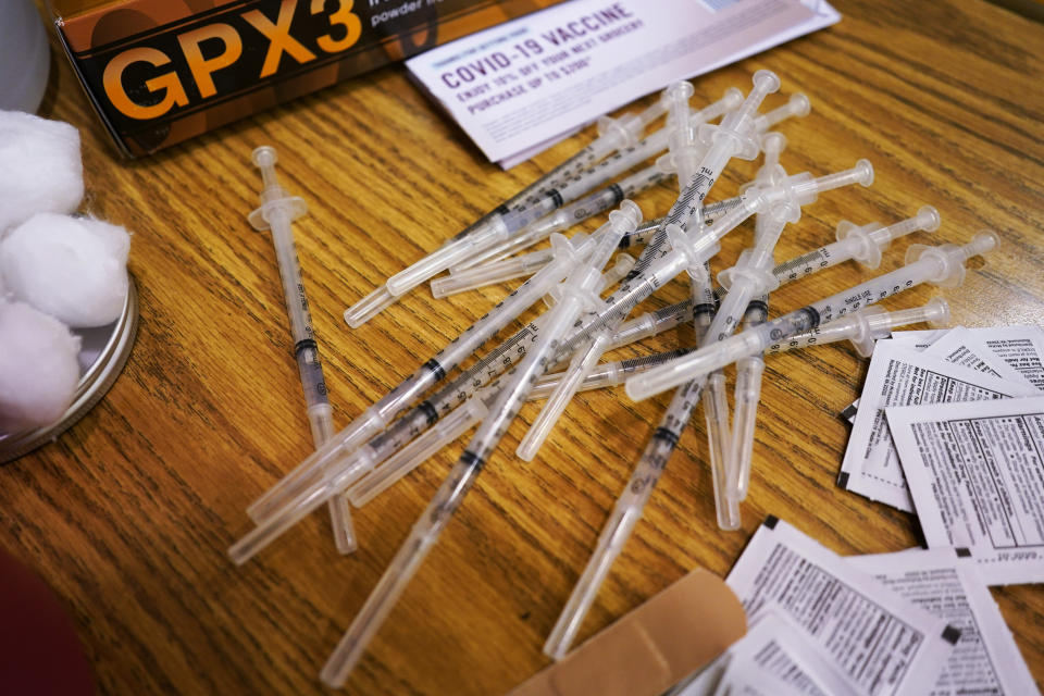 FILE - Prepared Pfizer COVID-19 vaccine syringes wait for patients at a middle school in Wheeling, Ill., June 11, 2021. Drugmaker Pfizer is expected to request authorization this week for an additional COVID-19 booster dose for seniors. That, according to a person familiar with the matter, who spoke on condition of anonymity. (AP Photo/Nam Y. Huh, File)