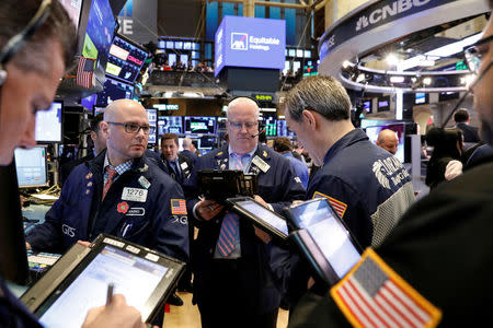 FILE PHOTO: Traders work on the floor of the New York Stock Exchange (NYSE) in New York, U.S., May 10, 2018. REUTERS/Brendan McDermid/File Photo