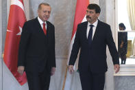 Turkish President Recep Tayyip Erdogan, left, is received by Hungarian President Janos Ader in the presidential Alexander Palace in Budapest, Hungary, Thursday, Nov. 7, 2019. (Tibor Illyes/MTI via AP)
