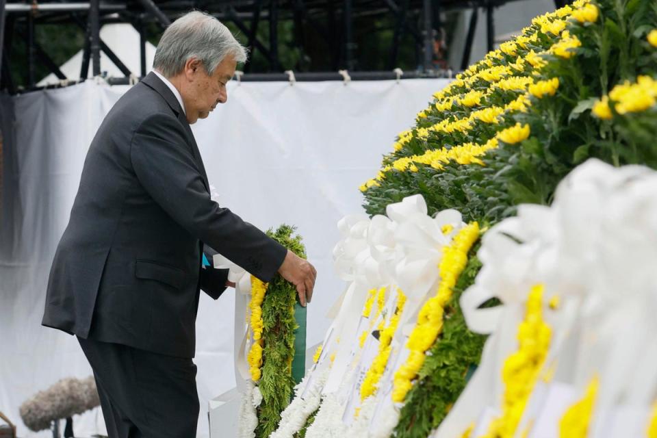 UN Secretary General Antonio Guterres lays a wreath at the cenotaph for the atomic bombing victims at the Hiroshima Peace Memorial Park during the ceremony marking the 77th anniversary of the atomic bombing in the city (AP)