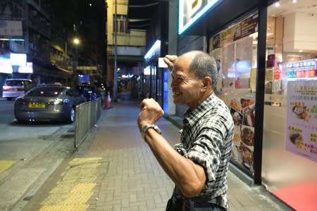 Lou Tit-Man, 73, stretches himself at Mong Kok in Hong Kong