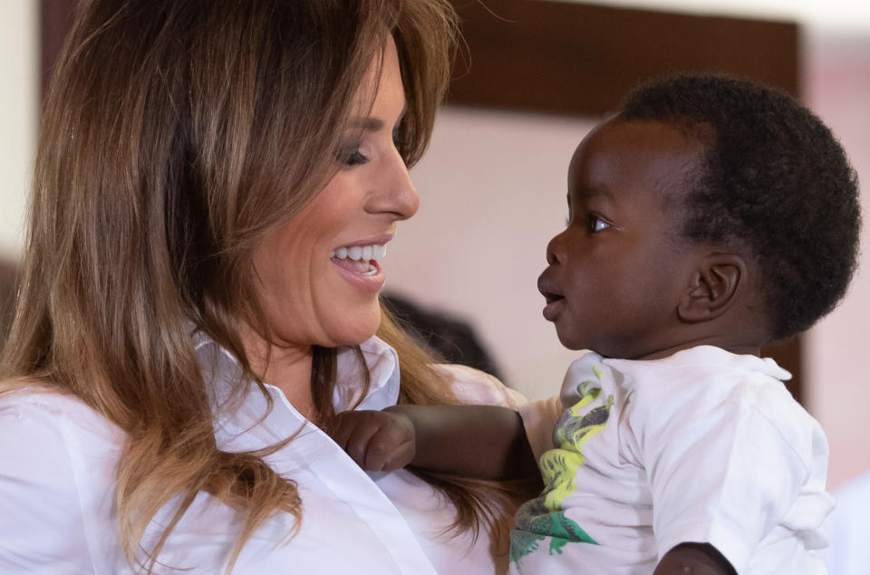 TOPSHOT - US First Lady Melania Trump (L) holds a baby as she visits the Nest Childrens Home Orphanage in Nairobi, on October 5, 2018, which primarily cares for children whose parents have been incarcerated. (Photo by SAUL LOEB / AFP) (Photo credit should read SAUL LOEB/AFP via Getty Images)