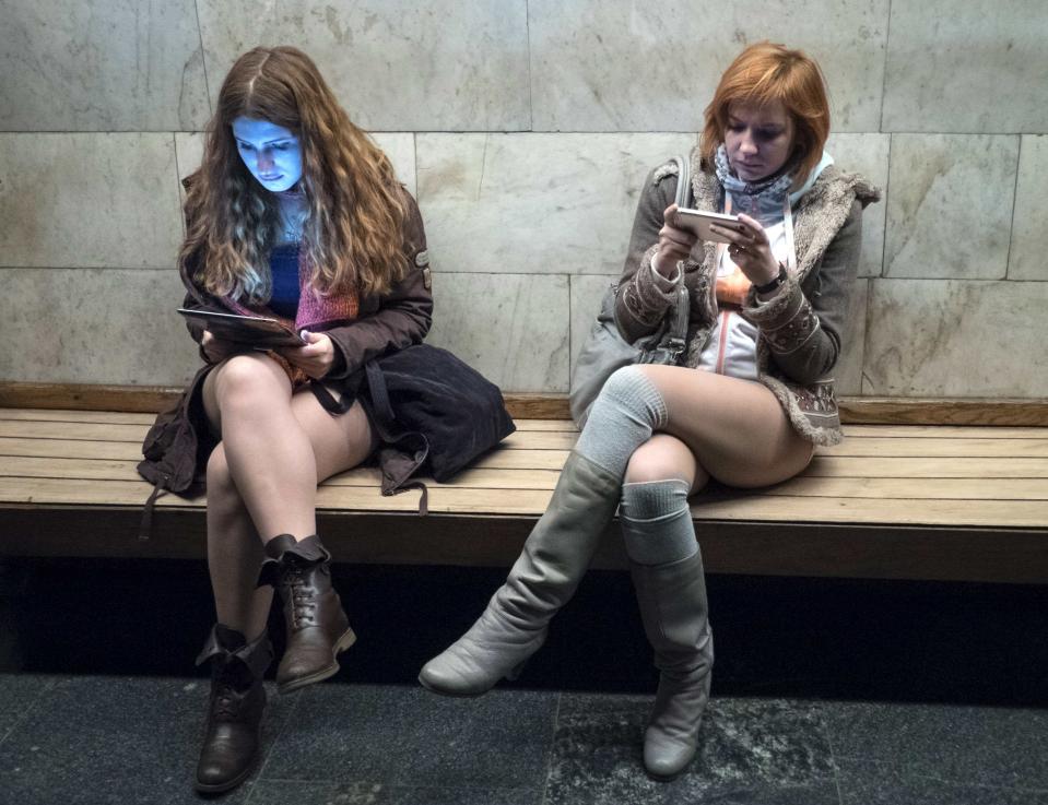 Passengers without pants wait on a underground platform during the "No Pants Subway Ride" in Kiev