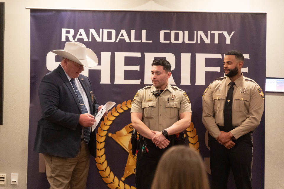 Randall County Sheriff Christopher Forbis presents awards recognizing outstanding service to Deputy Ricardo Perez and Deputy Shawn Polite Thursday the Randall County Sheriff's Office outside of Amarillo.