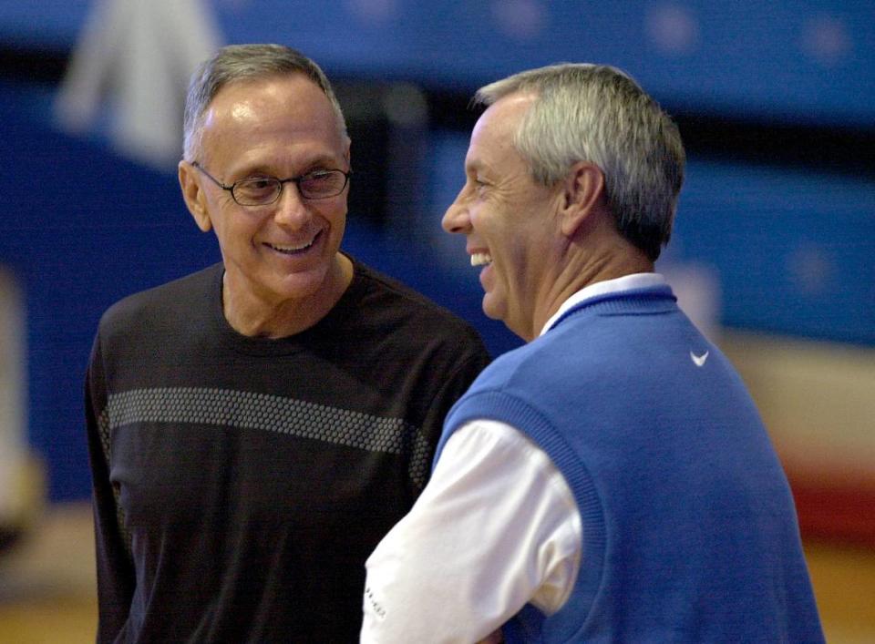 Philadelphia 76ers coach Larry Brown (left), who led Kansas to a national title in 1988, chatted with KU coach Roy Williams in 2001.