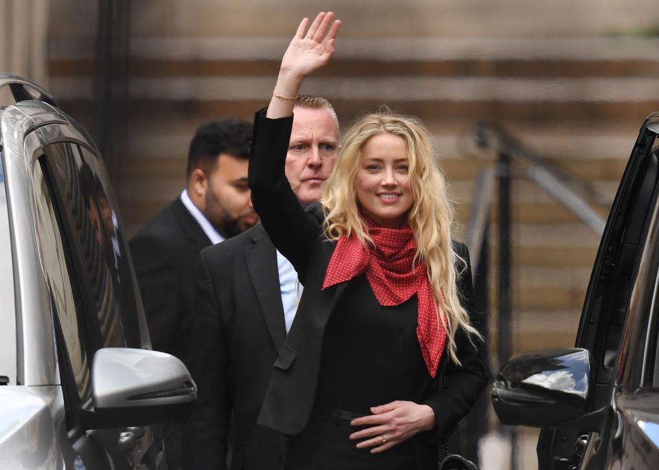 Amber Heard waves as she leaves court in London on July 16, 2020, after day eight of trial in the libel suit filed by her ex-husband Johnny Depp against The Sun tabloid.