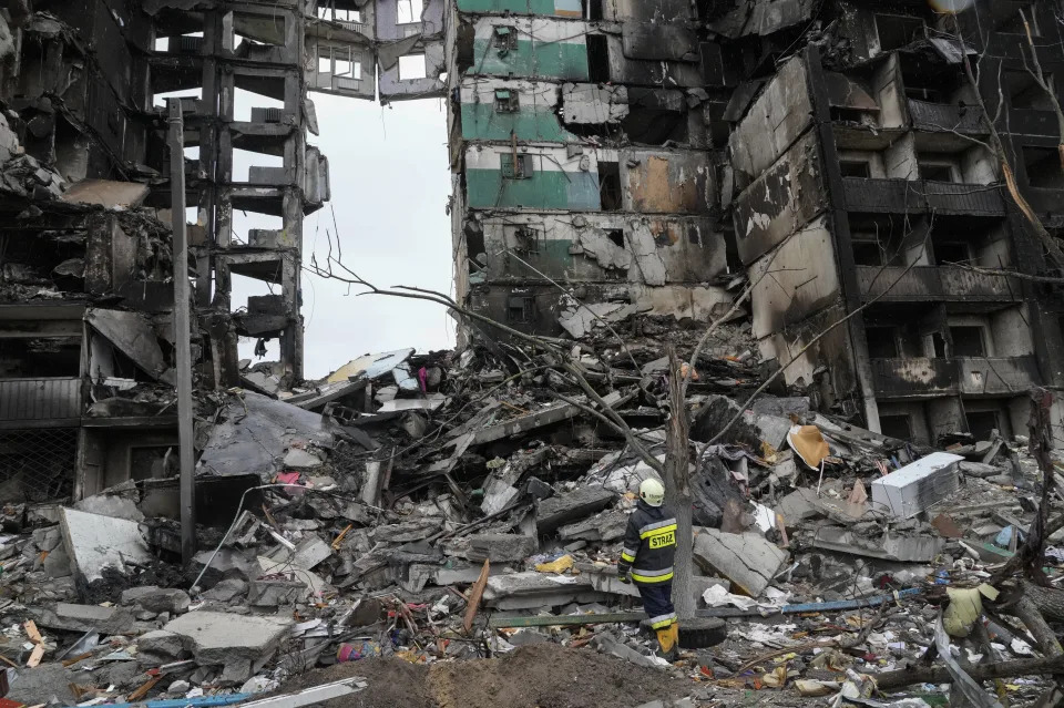 An emergency worker stands by the multi-storey building destroyed in a Russian air raid at the beginning of the Russia-Ukraine war in Borodyanka, close to Kyiv, Ukraine, Saturday, April 9, 2022.  (AP Photo/Efrem Lukatsky)