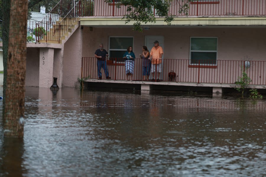 People look out at the flood waters from Hurricane Idalia surrounding their apartment complex on August 30, 2023 in Tarpon Springs, Florida. Hurricane Idalia is hitting the Big Bend area on the Gulf Coast of Florida. (Photo by Joe Raedle/Getty Images)