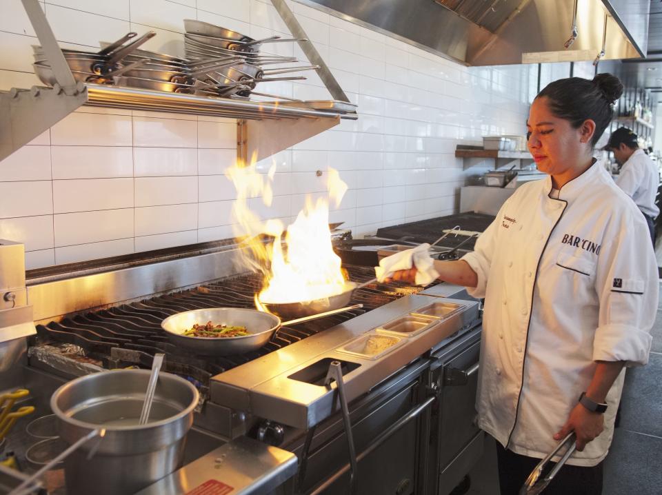 Bar ‘Cino executive chef Mariana Gonzalez-Trasvina stands over the grill at the Newport restaurant.