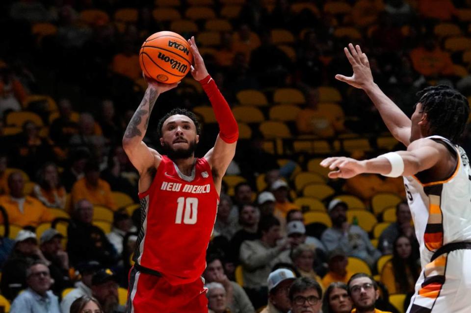Feb 6, 2024; Laramie, Wyoming, USA; New Mexico Lobos guard Jaelen House (10) shoots against Wyoming Cowboys guard Sam Griffin (3) during the second half at Arena-Auditorium.