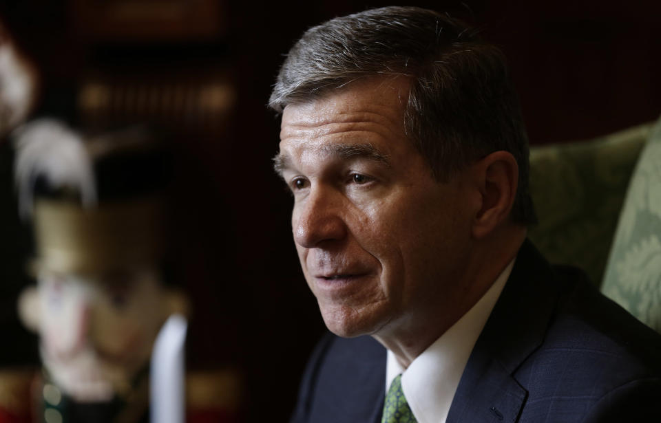 FILE - In this Wednesday, Dec. 19, 2018 file photo, North Carolina Gov. Roy Cooper listens during an interview at the Governor's mansion in Raleigh, N.C. North Carolina Gov. Roy Cooper signed an order Friday, Aug. 2, 2019 barring the state health department from allowing public funds to pay for conversion therapy for minors, a controversial practice aimed at changing young LGBT people’s sexual orientations.(AP Photo/Gerry Broome, File)