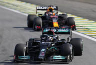 Mercedes' Lewis Hamilton, front, steers his car followed by Red Bull's Max Verstappen , during the Brazilian Formula One Grand Prix at the Interlagos race track in Sao Paulo, Brazil, Sunday, Nov. 14, 2021. (AP Photo/Andre Penner)