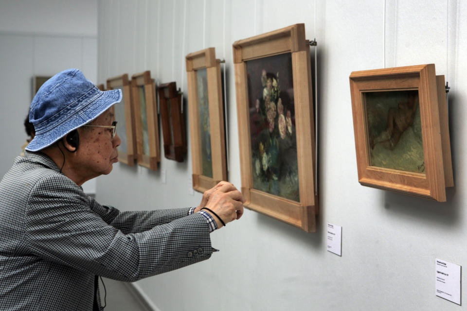 In this photo taken May 8, 2008, a man moves close to take a photo of the early 1887 painting "Nude Woman Reclining" by Vincent van Gogh at Kroeller-Mueller museum, Otterlo, eastern Netherlands. With the Van Gogh Museum in Amsterdam closed for renovations, the world's second-largest collection of the tortured Dutch master's work is stepping into the limelight. The lesser-known Kroeller-Mueller museum in the eastern Netherlands has revamped the layout of its central rooms, giving more space and focus to many of its top works. (AP Photo/Peter Dejong)