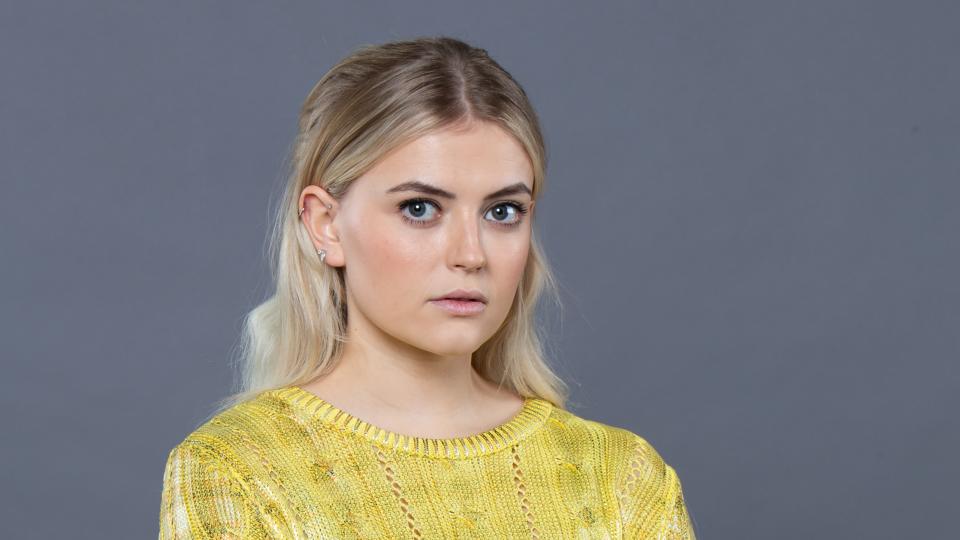 Bethany Platt wearing a yellow jumper.