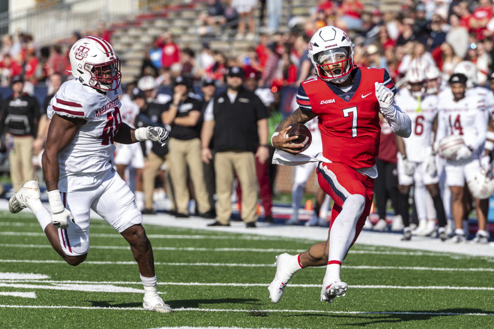 Liberty's Kaidon Salter, right, runs the ball for a touchdown past UMass' Jerry Roberts Jr. during the first half of an NCAA college football game, Saturday, Nov. 18, 2023, in Lynchburg, Va. (AP Photo/Robert Simmons)