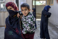 A mother with her malnourished child wait to receive help and check-up at a clinic that run by the WFP, in Kabul, Afghanistan, Thursday, Jan. 26, 2023. A spokesman for the U.N. food agency says malnutrition rates in Afghanistan are at record highs. Aid agencies have been providing food, education, healthcare and other critical support to people, but distribution has been severely impacted by a Taliban edict banning women from working at national and international nongovernmental groups. (AP Photo/Ebrahim Noroozi)