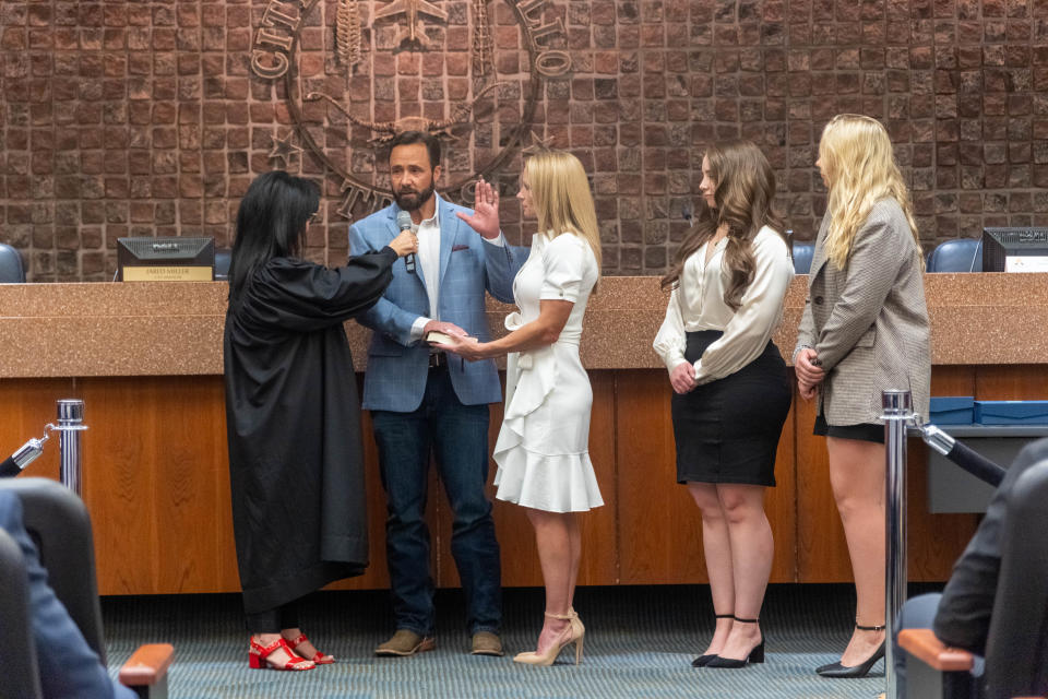 Newly elected Mayor Cole Stanley is sworn in with his family by  Justice of the Peace, Joanne Garcia Flores Tuesday at city hall in Amarillo.