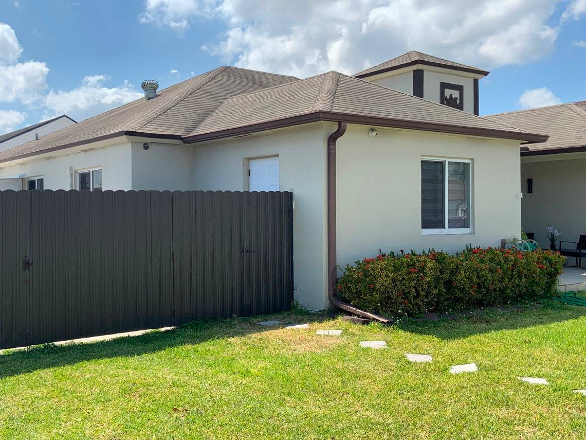 The pavers from the sidewalk to the gate in the fence to a small area with a side door on the north side of 15856 SW 143rd Ct.