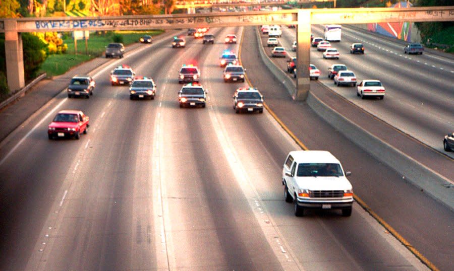 In this June 17, 1994 file photo, a white Ford Bronco, driven by Al Cowlings carrying O.J. Simpson, is trailed by Los Angeles police cars as it travels on a freeway in Los Angeles. Simpson’s ex-wife, Nicole Brown Simpson, and her friend Ronald Goldman are found dead in Los Angeles. Simpson is later arrested after a widely televised freeway chase in his white Ford Bronco. (AP Photo/Joseph Villarin, File)