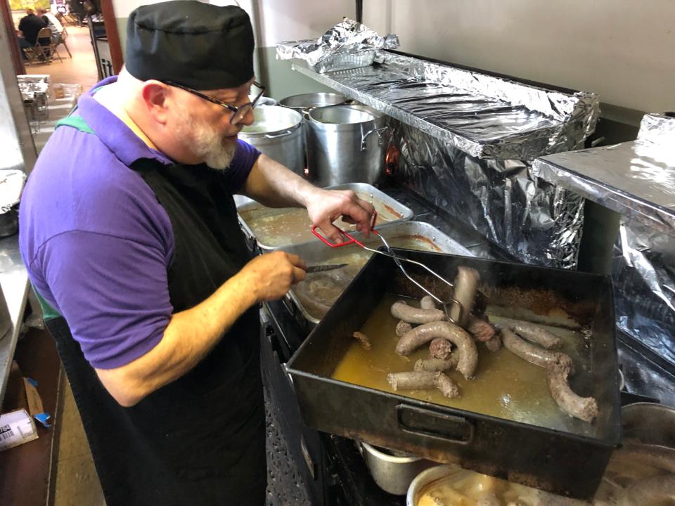 Tim Hudak cooks Polish sausage as Dyngus Day festivities begin Monday, April 10, 2023, at the West Side Democratic & Civic Club in South Bend.