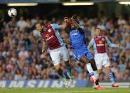 Chelsea's Demba Ba (right) and Aston Villa's Ron Vlaar (left) battle for the ball in the air