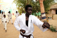 Abdel Rahman, 20, a former Koran student, called a talibe, who became a karate coach at Maison de la Gare, an organisation that helps talibe street children reintegrate into society, trains talibe children in the courtyard of the organisation, in Saint-Louis, Senegal, February 7, 2019. REUTERS/Zohra Bensemra