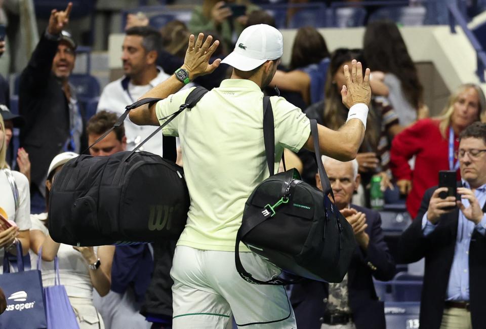 Bulgaria's Grigor Dimitrov who retired due to injury, leaves the court after the men's quarterfinals match against USA's Frances Tiafoe (AFP via Getty Images)