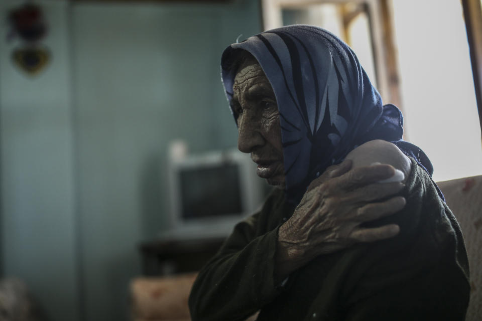 Altun Yigit, 83, rests after she was administered a CoronaVac vaccine made by China's Sinovac Biotech Ltd. by a visiting medical team at her house in the isolated village of Gumuslu of the district of Sivas, central Turkey, Friday, Feb. 26, 2021. (AP Photo/Emrah Gurel)