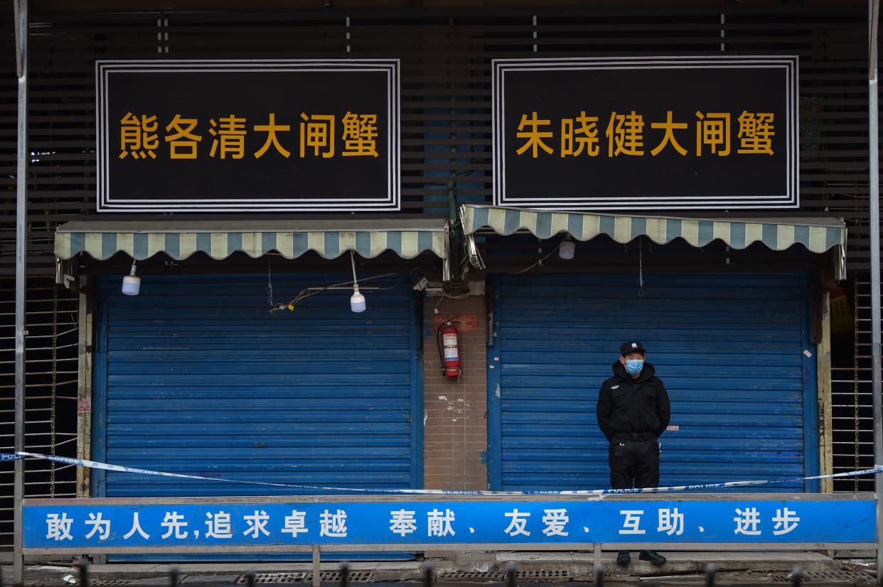 A security guard stands outside the Huanan Seafood Wholesale Market, where the coronavirus was detected, in Wuhan, China, on Jan. 24, 2020. 