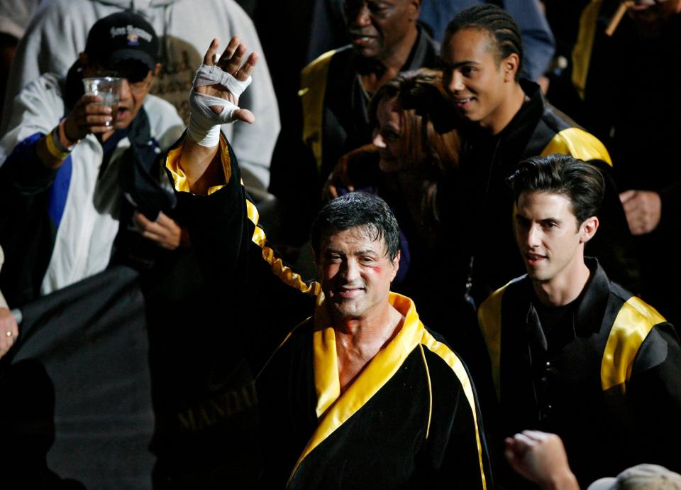 Fans cheer as Sylvester Stallone, center, acts in a scene being shot for the film 