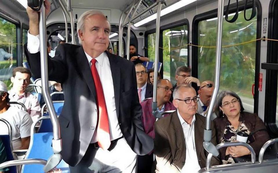 The launch of rapid-transit bus service on the South Dade Transitway spanned two administrations. It was approved under then-Mayor Carlos Gimenez, picutured on a bus tour of the route. To his right is his successor and current mayor, Daniella Levine Cava.