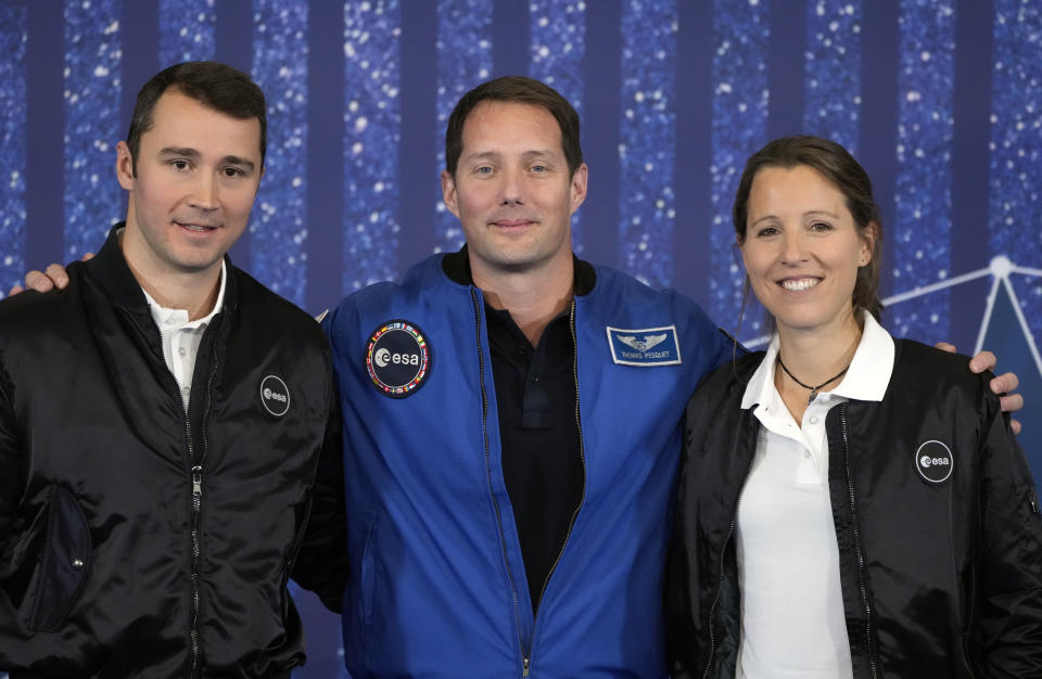 Members of ESA's new class of astronauts Sophie Adenot, right, and Arnaud Prost, left, pose with French astronaut Thomas Pesquet during the ESA Council at Ministerial level (CM22) at the Grand Palais Ephemere, in Paris, Wednesday, Nov. 23, 2022. The European Space Agency has selected a disabled former athlete to be among its its newest astronaut recruits as part of its first recruitment drive in over a decade that aimed to bring diversity to space travel. (AP Photo/Francois Mori)