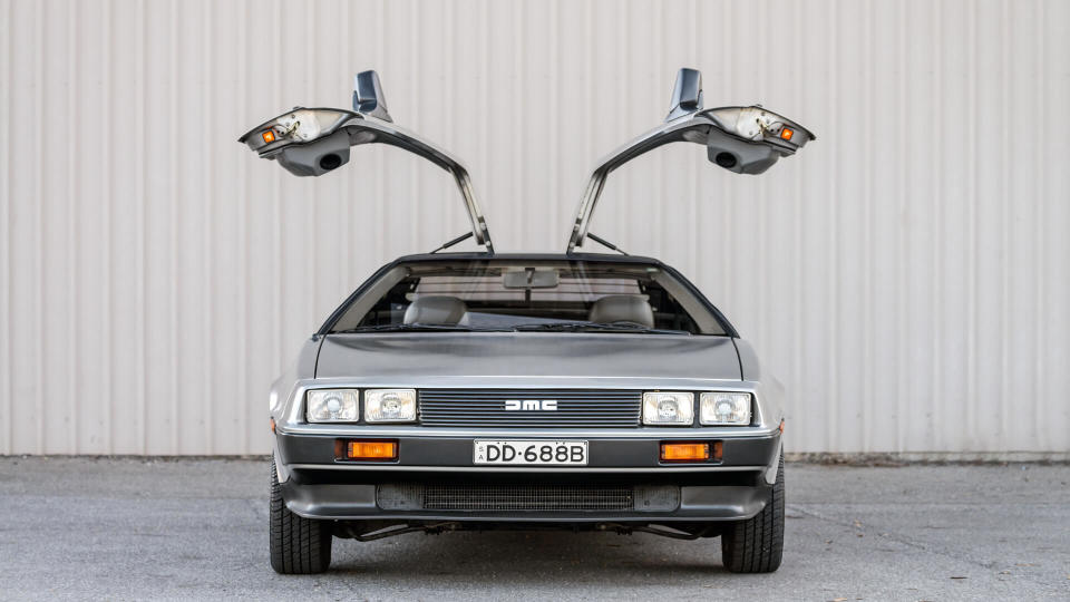 Adelaide, Australia - September 7, 2013: DeLorean DMC-12 car with opened doors parked on street near shed - Image.