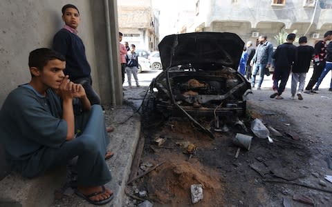 People inspect damage after rocket attacks at the Abu Salim neighborhood in Tripoli, Libya on April 17, 2019 - Credit: Hazem Turkia/Anadolu Agency/Getty Images