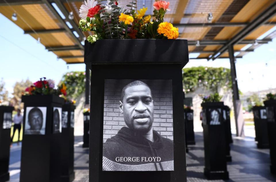 SAN DIEGO, CALIFORNIA – JULY 20: A photograph of George Floyd (C) is displayed along with other photographs at the Say Their Names memorial exhibit at Martin Luther King Jr. Promenade on July 20, 2021 in San Diego, California. The traveling memorial features photographs of 200 Black Americans who lost their lives due to systemic racism and racial injustice and is sponsored by the San Diego African American Museum of Fine Art (SDAAMFA). Former Minneapolis police officer Derek Chauvin was sentenced to 22 years and six months in prison after being convicted of murder in the death of George Floyd. (Photo by Mario Tama/Getty Images)