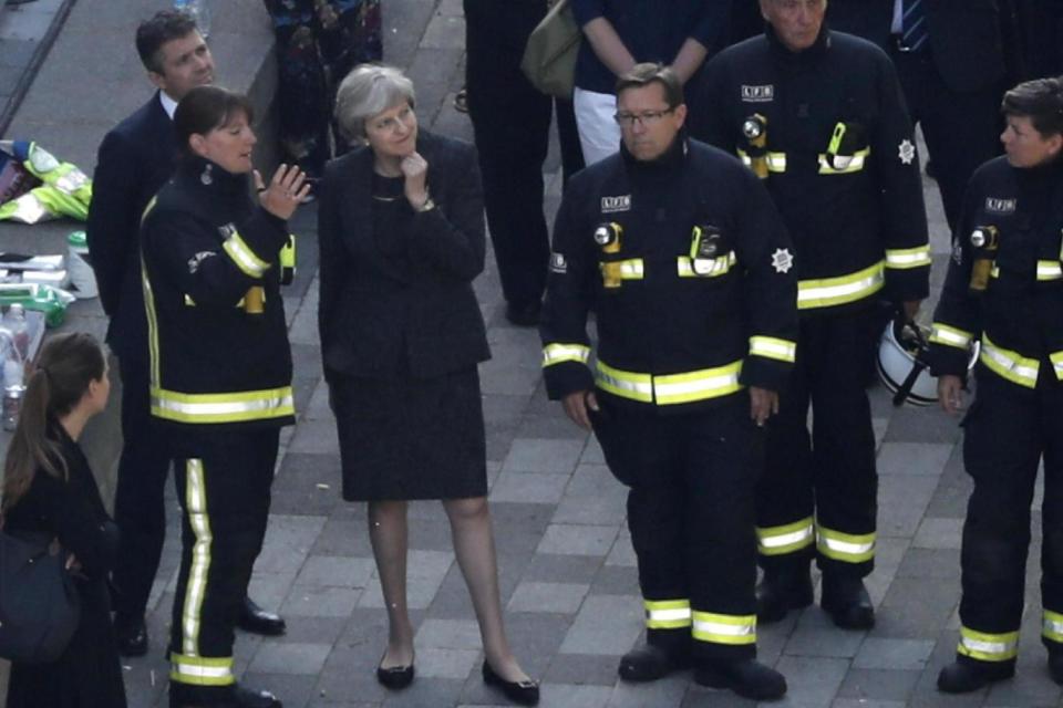Dany Cotton, left, speaks to Prime Minister Theresa May at the site of the Grenfell Tower (AFP/Getty Images)