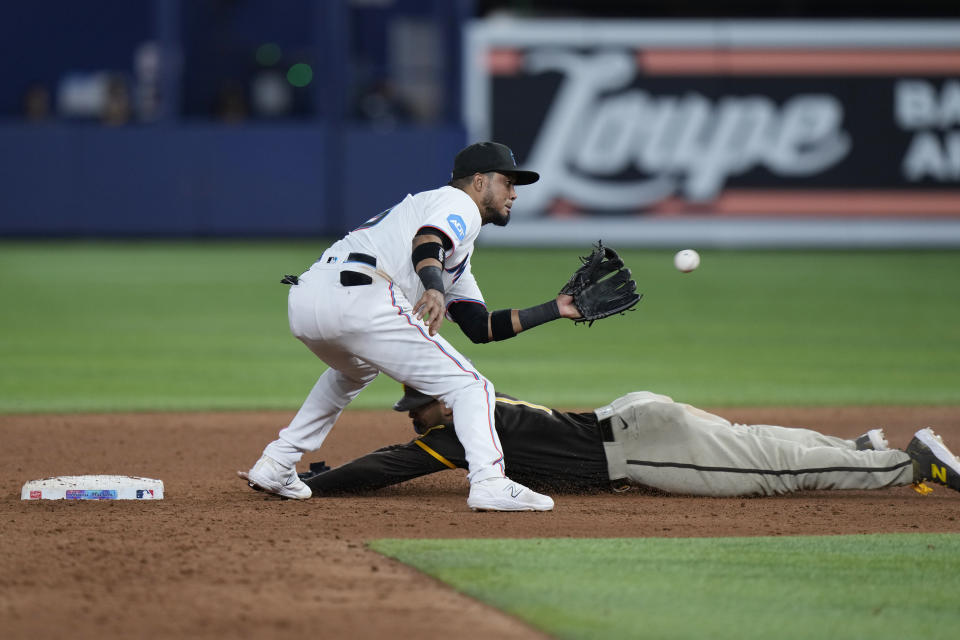 Miami Marlins second baseman Luis Arraez is unable to tag out San Diego Padres' Trent Grisham after Grisham stole second base during the ninth inning of a baseball game, Tuesday, May 30, 2023, in Miami. (AP Photo/Wilfredo Lee)