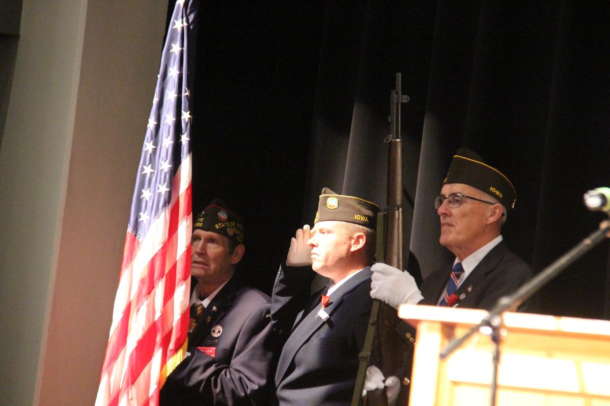 The flag is saluted during the singing of the national anthem at the beginning of the Veterans Day Celebration on Thursday, Nov. 11, 2021, at Perry Performing Arts Center.