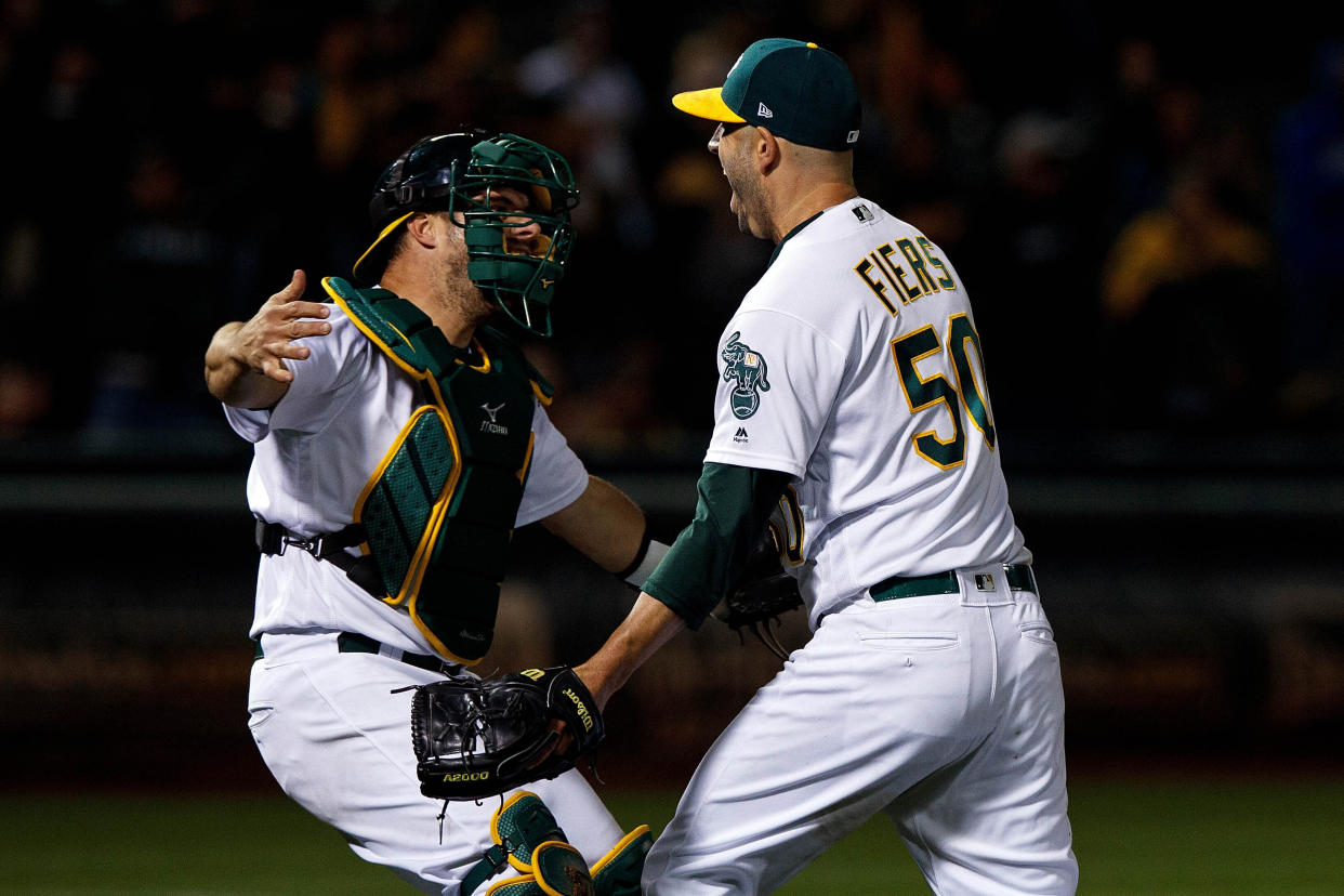 OAKLAND, CA - MAY 07: Mike Fiers #50 of the Oakland Athletics celebrates with Josh Phegley #19 after pitching a no hitter against the Cincinnati Reds at the Oakland Coliseum on May 7, 2019 in Oakland, California. The Oakland Athletics defeated the Cincinnati Reds 2-0. (Photo by Jason O. Watson/Getty Images)