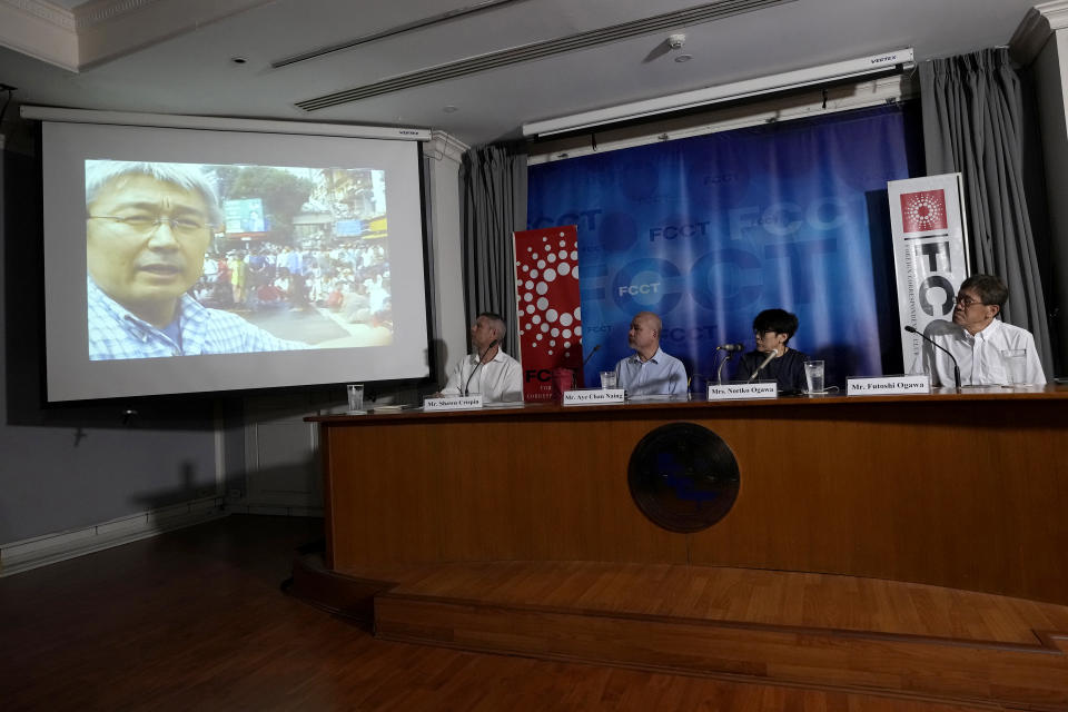 From left to right, Shawn Crispin, Committee to Protect Journalists, Aye Chan Naing of Democratic Voice of Burma, Noriko Ogawa, sister of Kenji Nagai, and her husband Futoshi Ogawa, watch video taken by Japanese Kenji Nagai when Nagai recorded a demonstration in downtown Yangon in September 2007, at the Foreign Correspondents Club in Bangkok, Thailand, Wednesday, April 26, 2023. The video camera, dropped by a Japanese journalist when he was shot dead during a street protest in Myanmar and presumed lost, has been handed over to his sister, more than 15 years after his death. (AP Photo/Sakchai Lalit)
